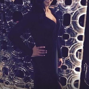 Black long sleeve dress with slit on the right.