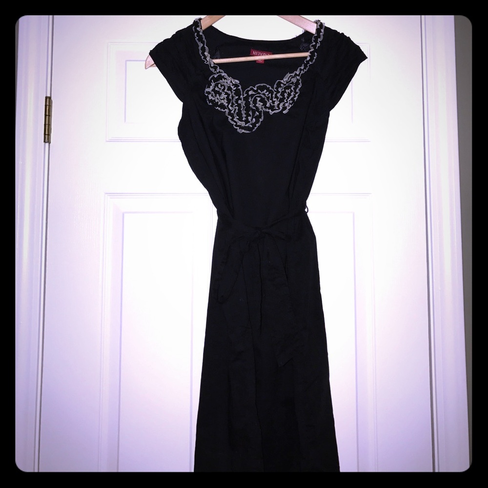 Black dress with tan ruffle flowers at neck