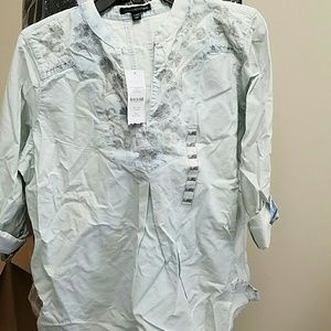 Tunic with slight rip in back