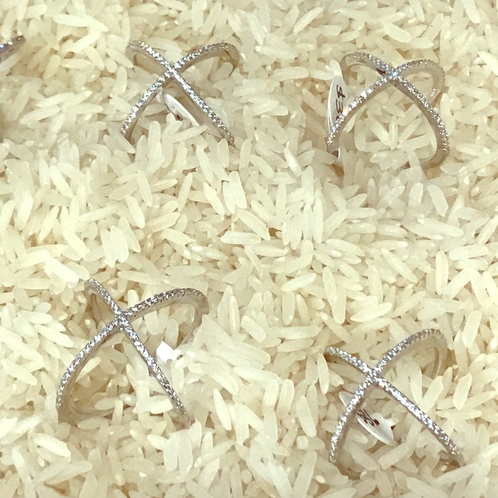 Cubic zircon on silver X ring .