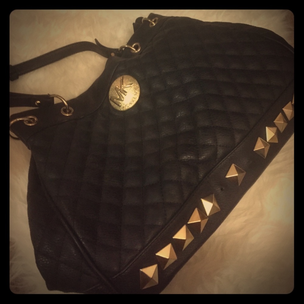 Black purse with gold studs.