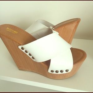 White cross strap slip on wedge heels.