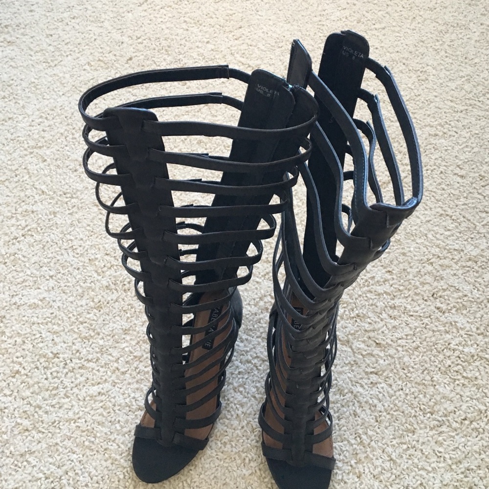 Black knee-high gladiator heels. Size 8 (US).