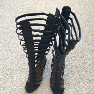 Black knee-high gladiator heels. Size 8 (US).