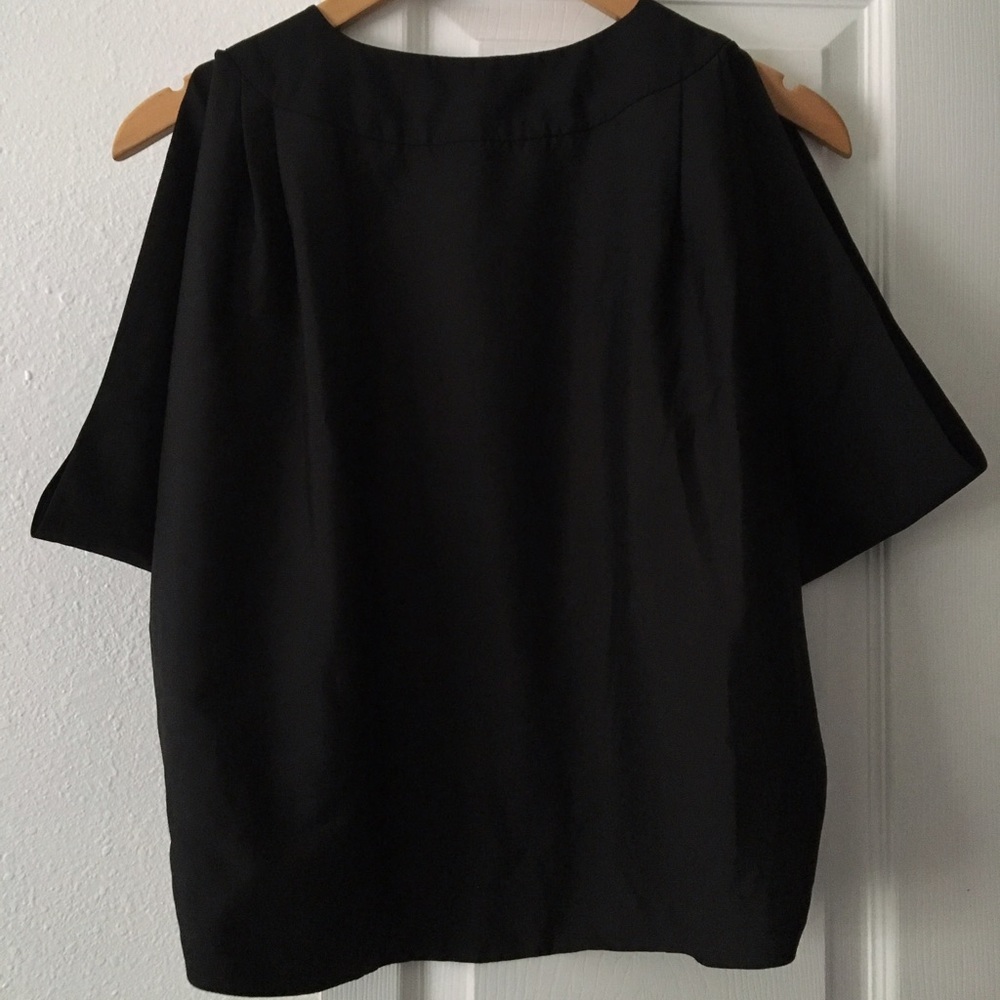 Black top with exposed shoulders and open back