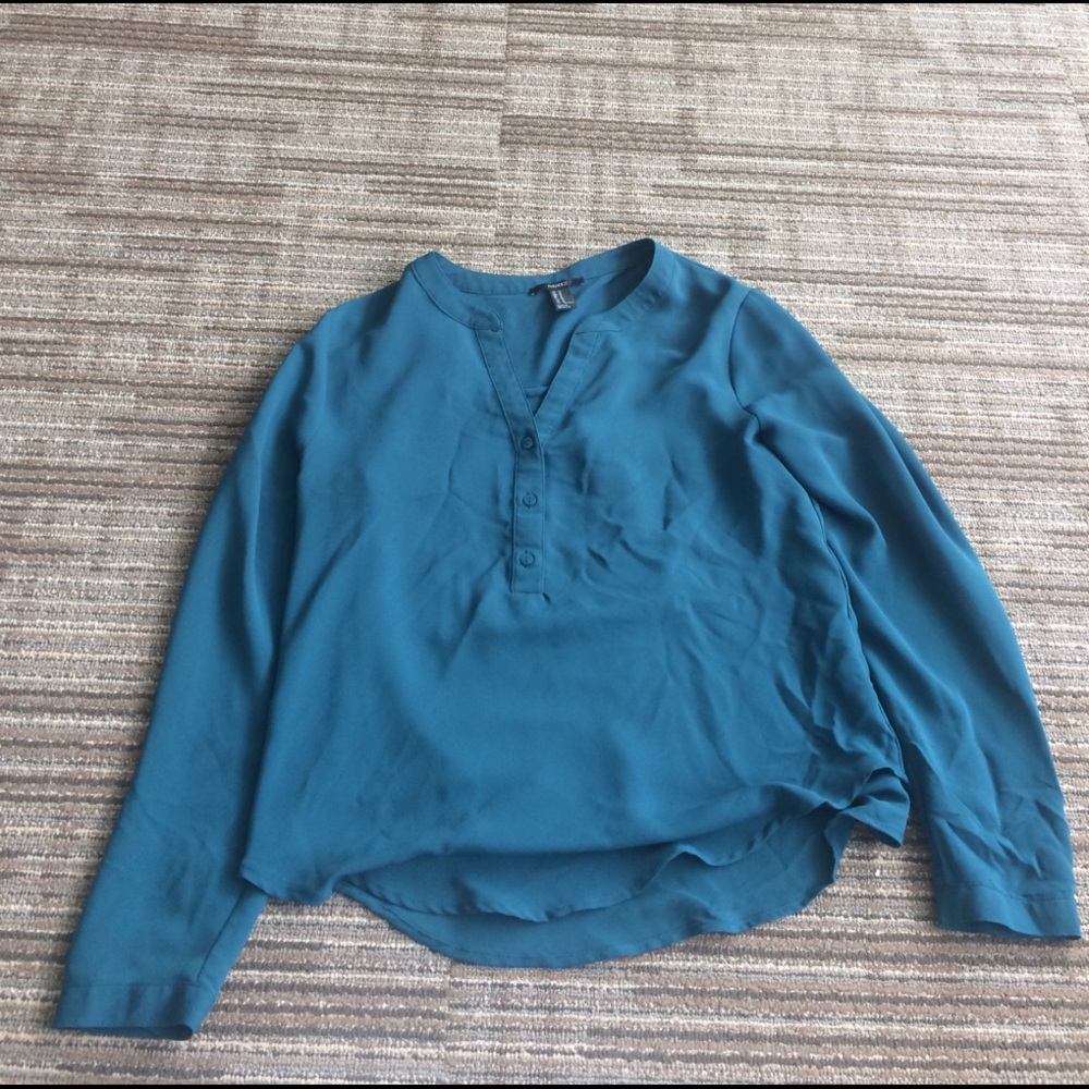 A blue/grew top with buttons down the first