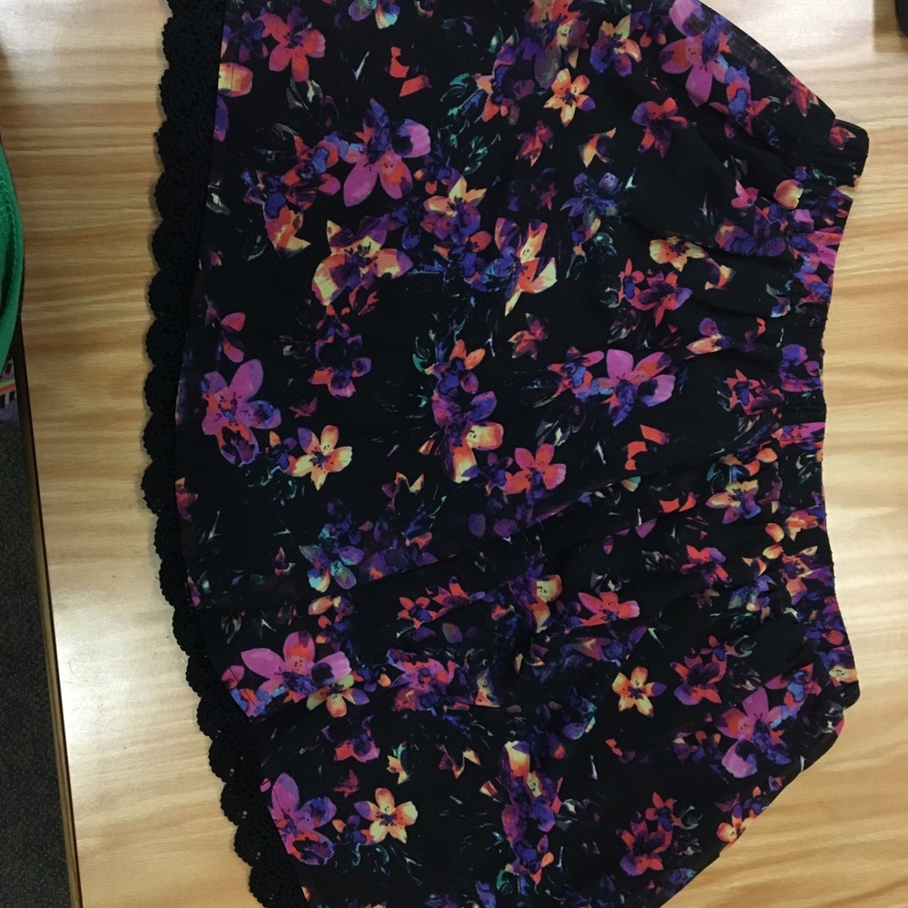 Black skirt with flowers. Lace decal at bottom.