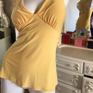 Yellow top it's large but fits medium