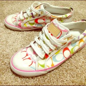 White coach shoes with multicolor C's.