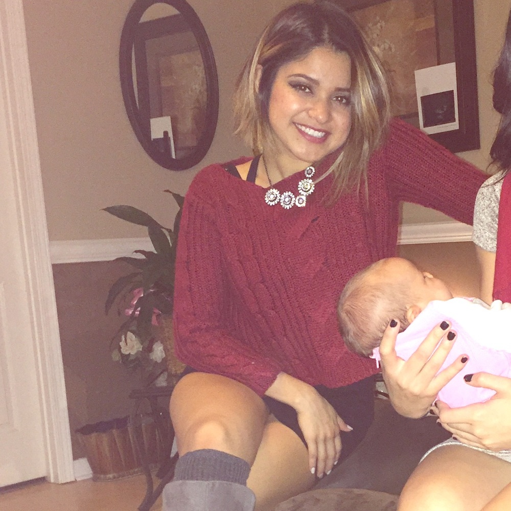 Red sweater top. Left