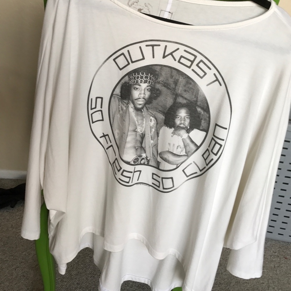 A flowy white shirt with outkast logo and picture