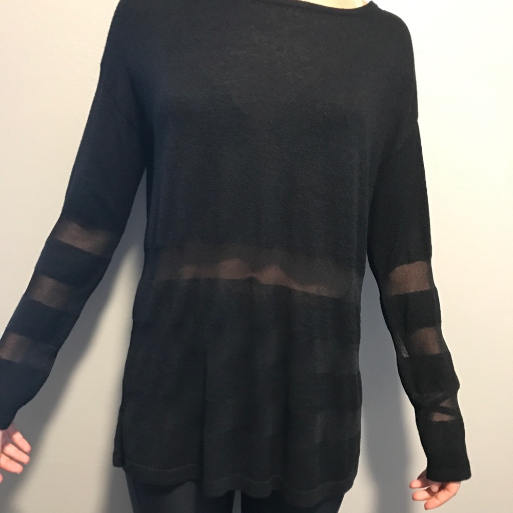 Black sweater with striped bottom. Size small.