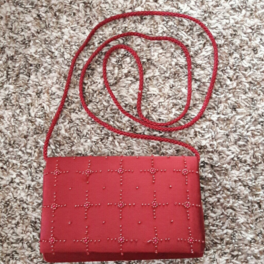 Clutch the color is a pinkish burgundy