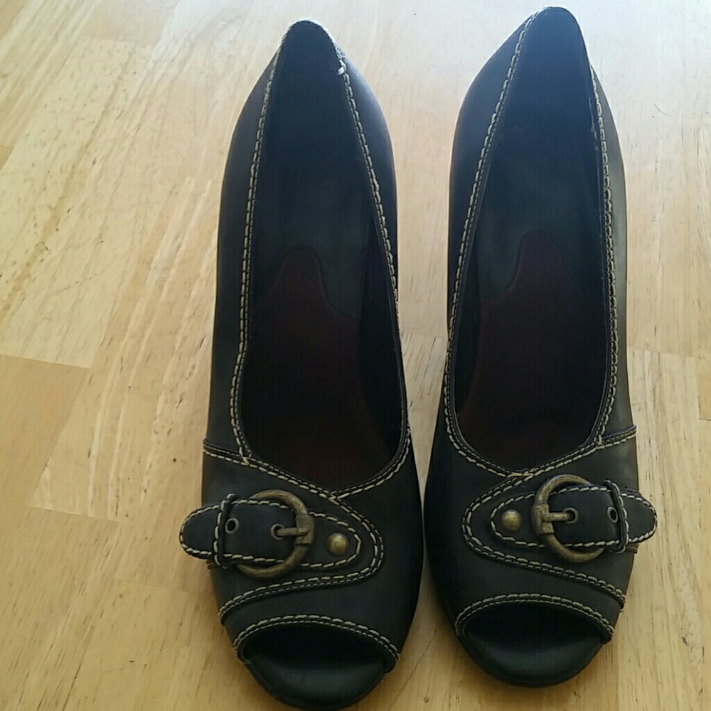 Black peep toe heels with gold buckle.