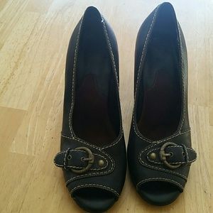 Black peep toe heels with gold buckle.