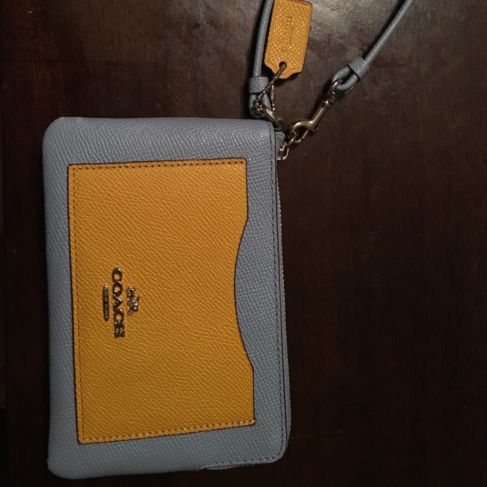 blue and yellow Coach wristlet