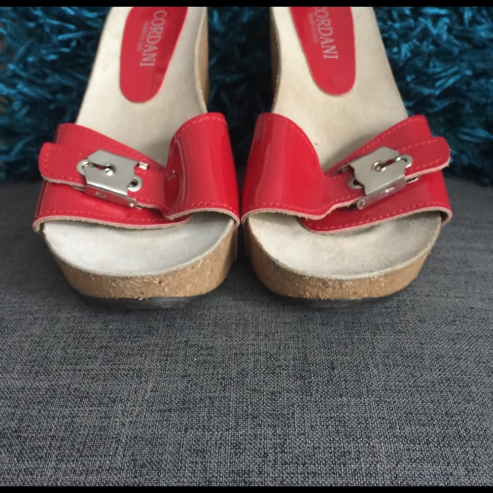 Red patent Cordani wedges.