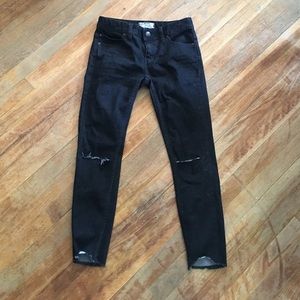 Distressed black skinny jeans