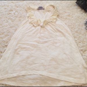 White tank with ruffles around the neck