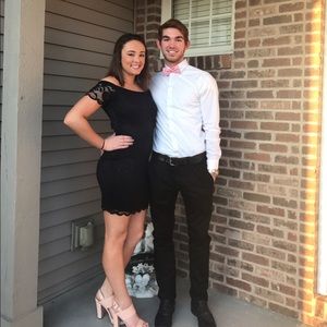 A form fitting black lace dress