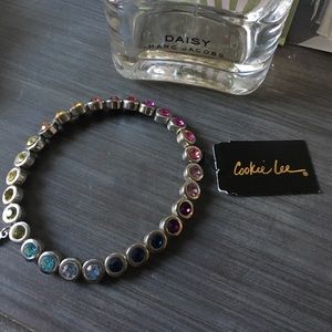 Silver bracelet with colored crystals.