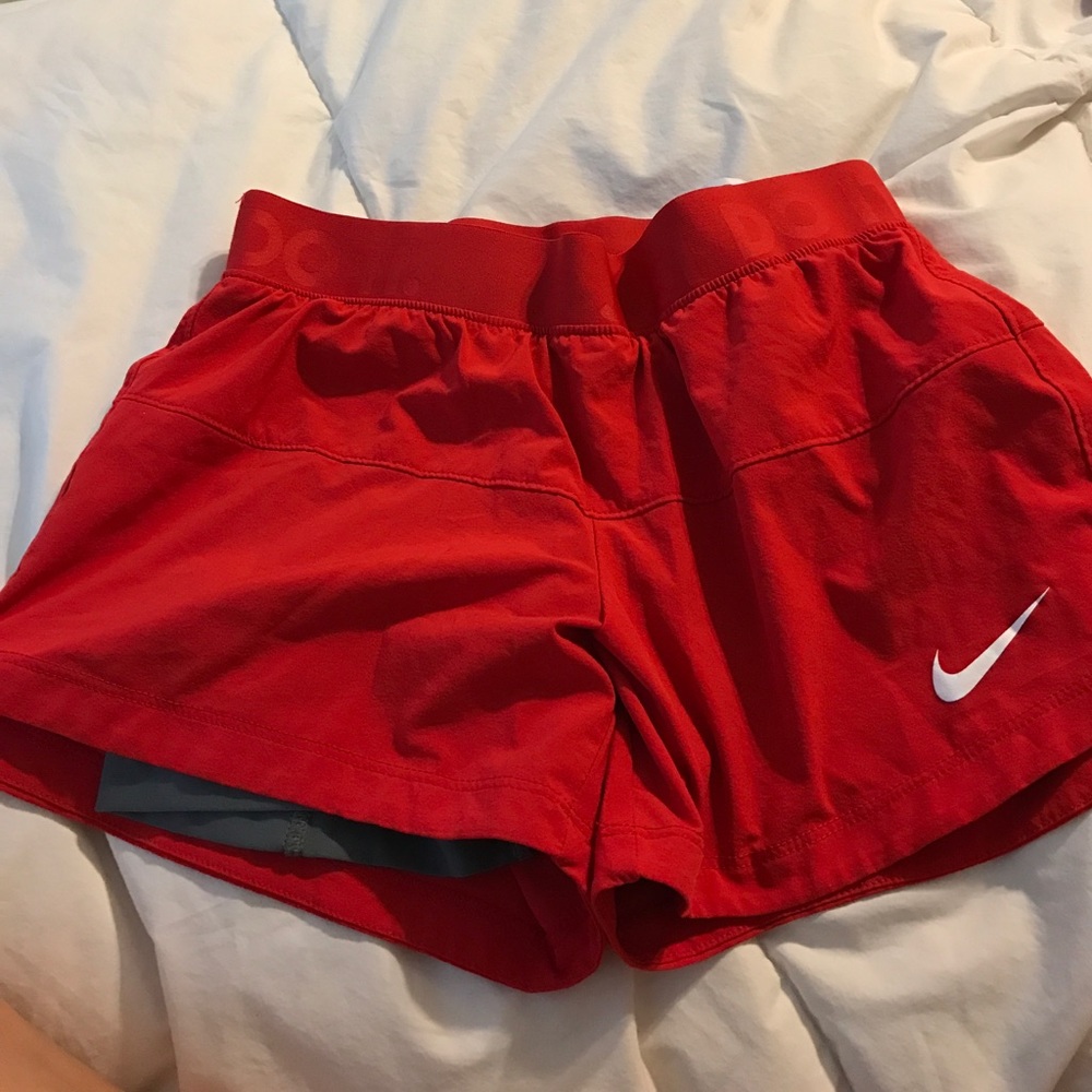 Red Nike shorts with gray spandex