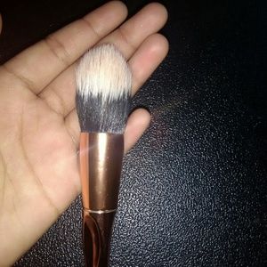 Domed foundation brush with metallic handle.