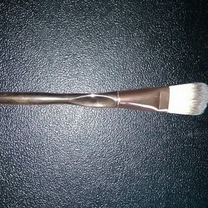 Flat foundation brush with metallic handle.