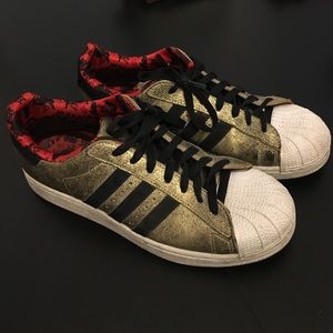 Gold and black Adidas Superstars