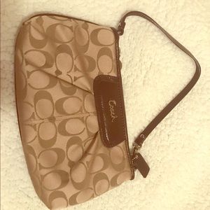 Tan coach signature wristlet.