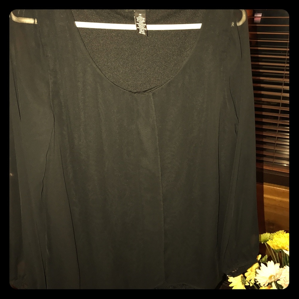Black blouse with sheer sleeves.