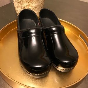 Sanita professional patent black clogs