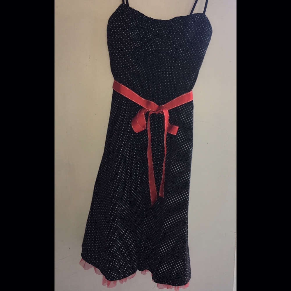Black dress with white polka dots and red tulle