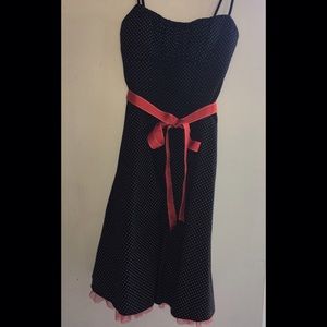 Black dress with white polka dots and red tulle