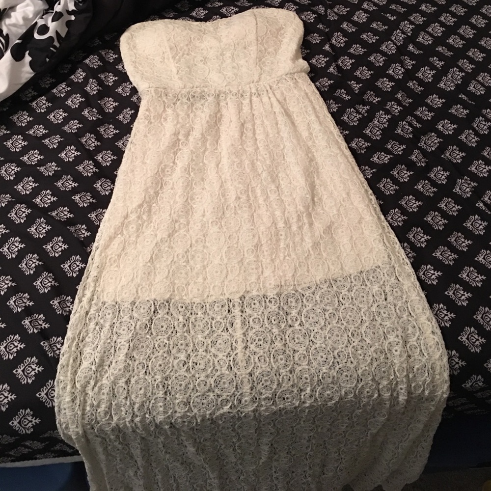 Floor length white dress with cutout in back.