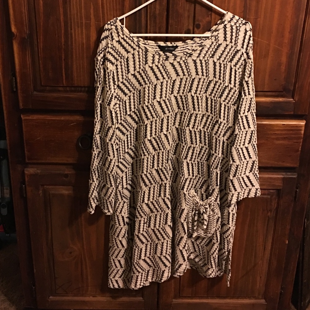 cream and black dress or top with leggings