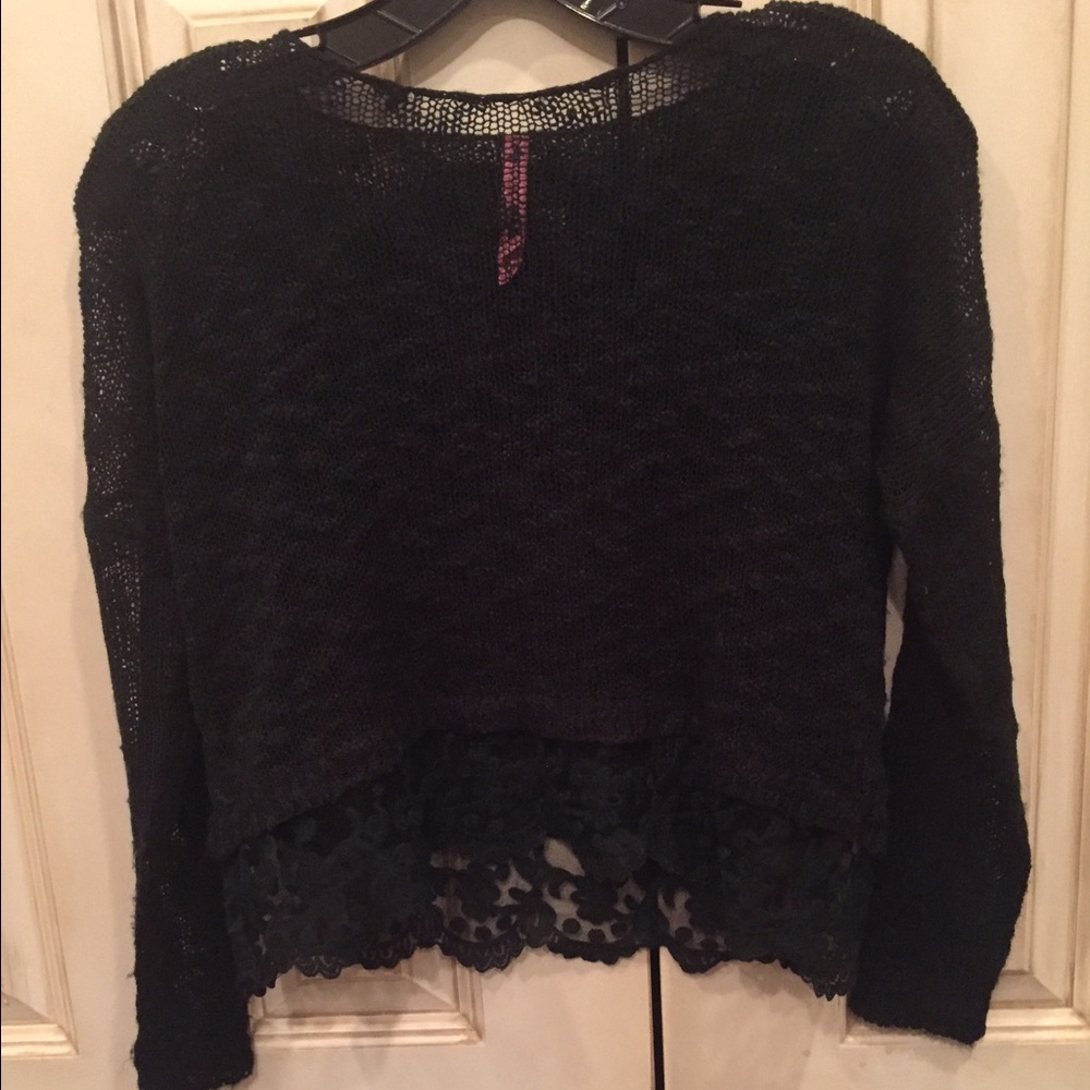 Black sheer sweater with lace on bottom.