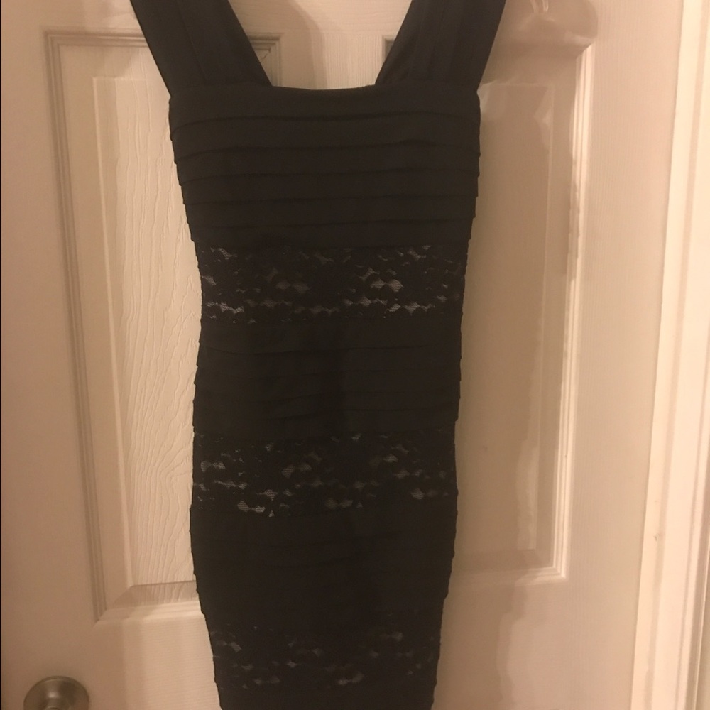 Women's form fitting little black lace dress.