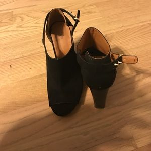 Black suede open toe heels with strap.