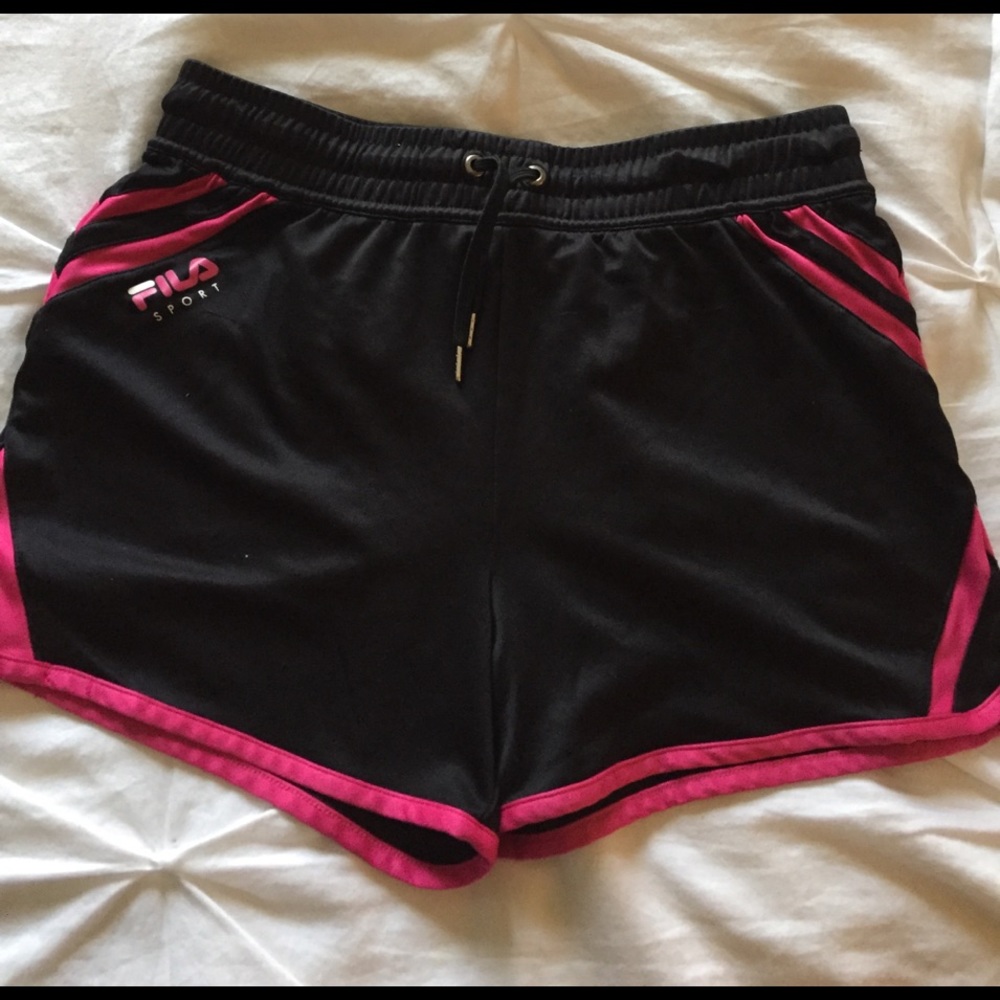 Lighting worn Fila athletic shorts