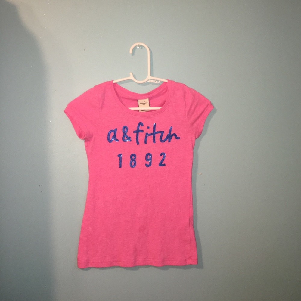 Pink tee with sparkly blue writing