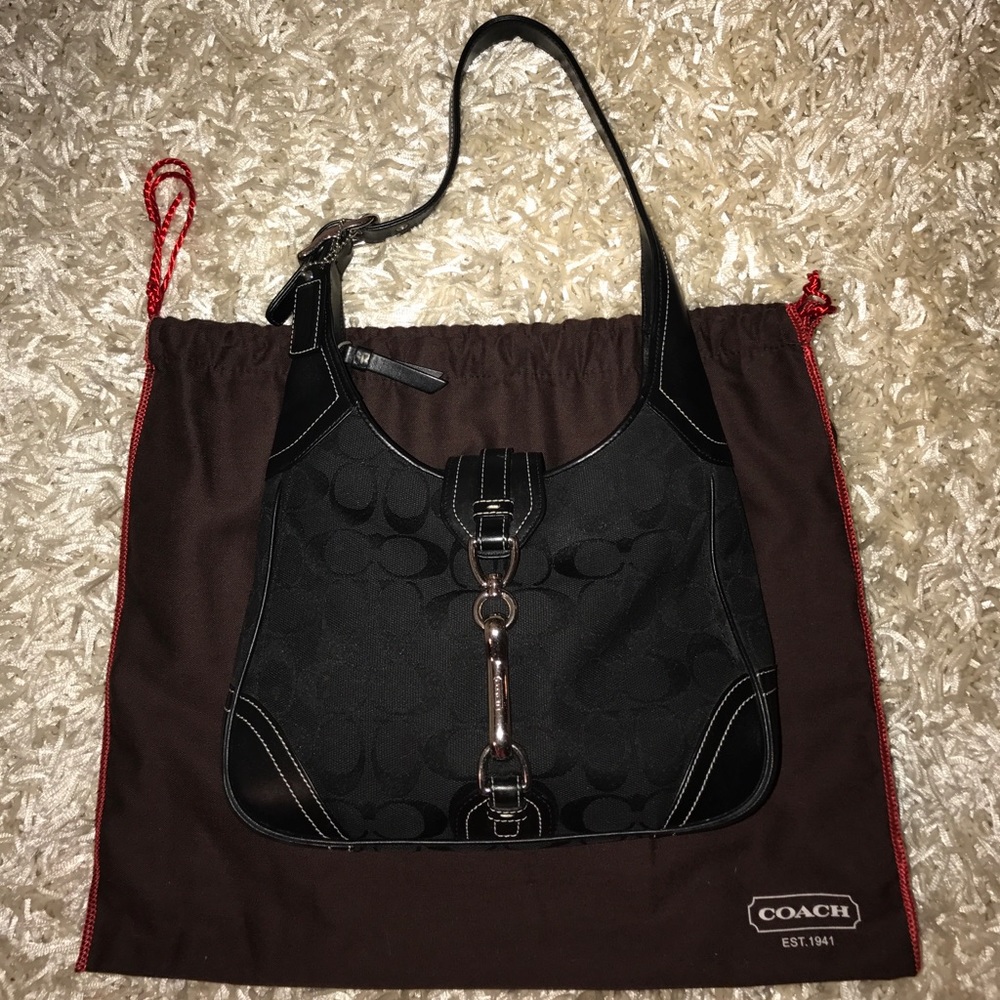 Blach Coach handbag with a buckle.