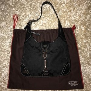 Blach Coach handbag with a buckle.