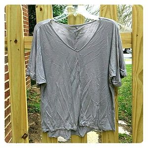 Loose fitting grey v-neck blouse.