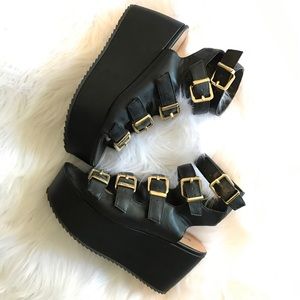 Flatform sandal w/ strappy gold buckles.