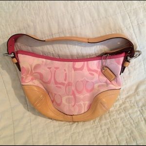 Pink Coach bag with leather trim and strap.