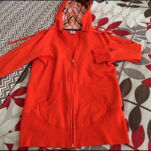 Alo orange athletic jacket.