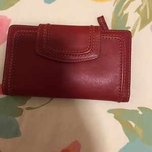 Women's red Fossil wallet.