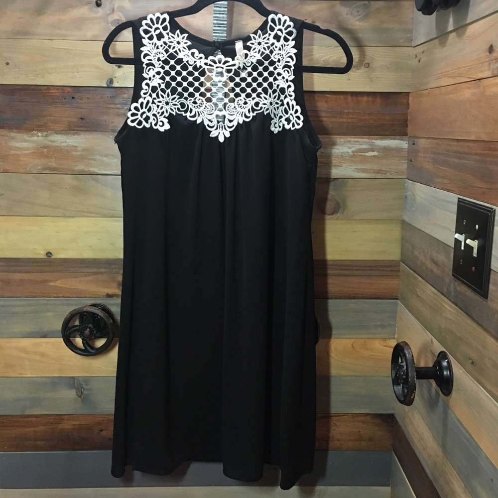 Black sleeveless dress with cream crochet accent