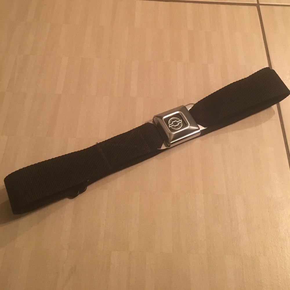 Seatbelt belt adjustable with Chevy emblem.